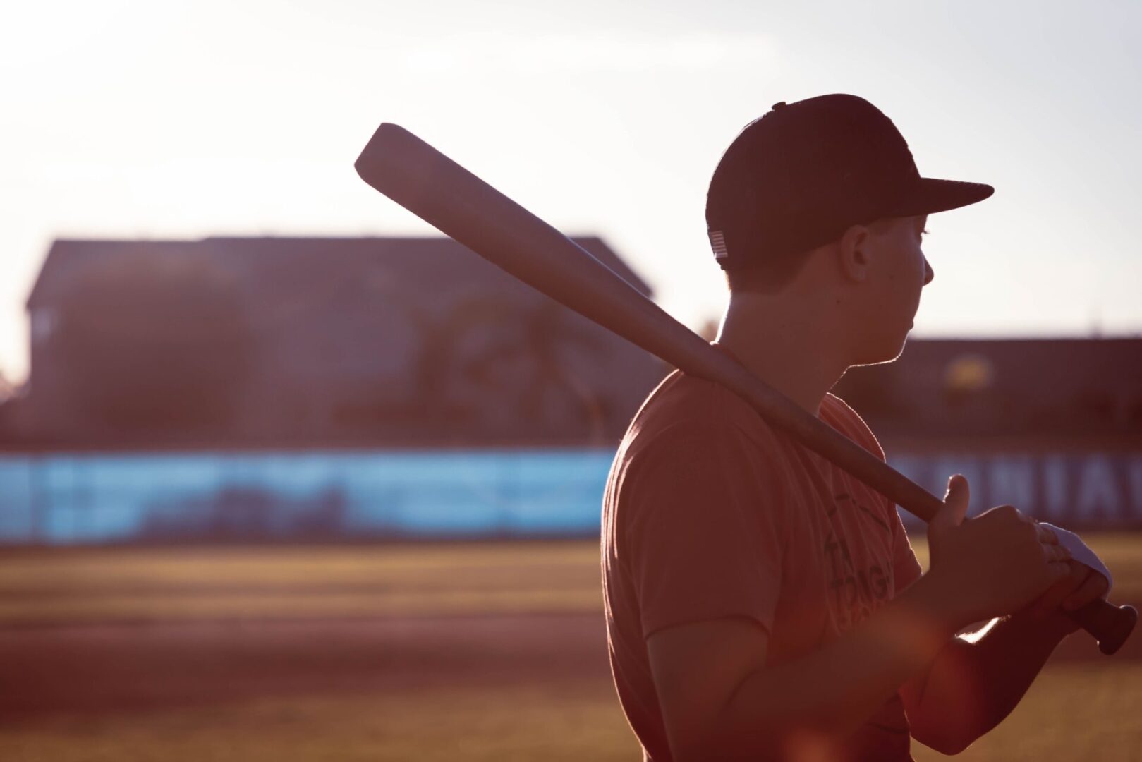 A man holding a baseball bat on top of a field.